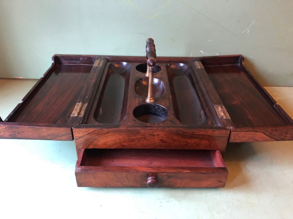 A dark rosewood rectangular desk tidy featuring a central turned wood and brass handle, hinged lids, and a moulded base. View XI