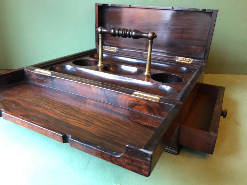 A dark rosewood rectangular desk tidy featuring a central turned wood and brass handle, hinged lids, and a moulded base. View XIII
