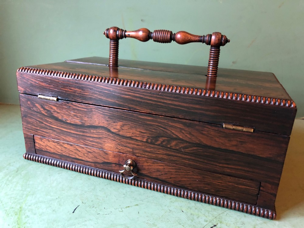 A dark rosewood rectangular desk tidy featuring a central turned wood and brass handle, hinged lids, and a moulded base. View XIV