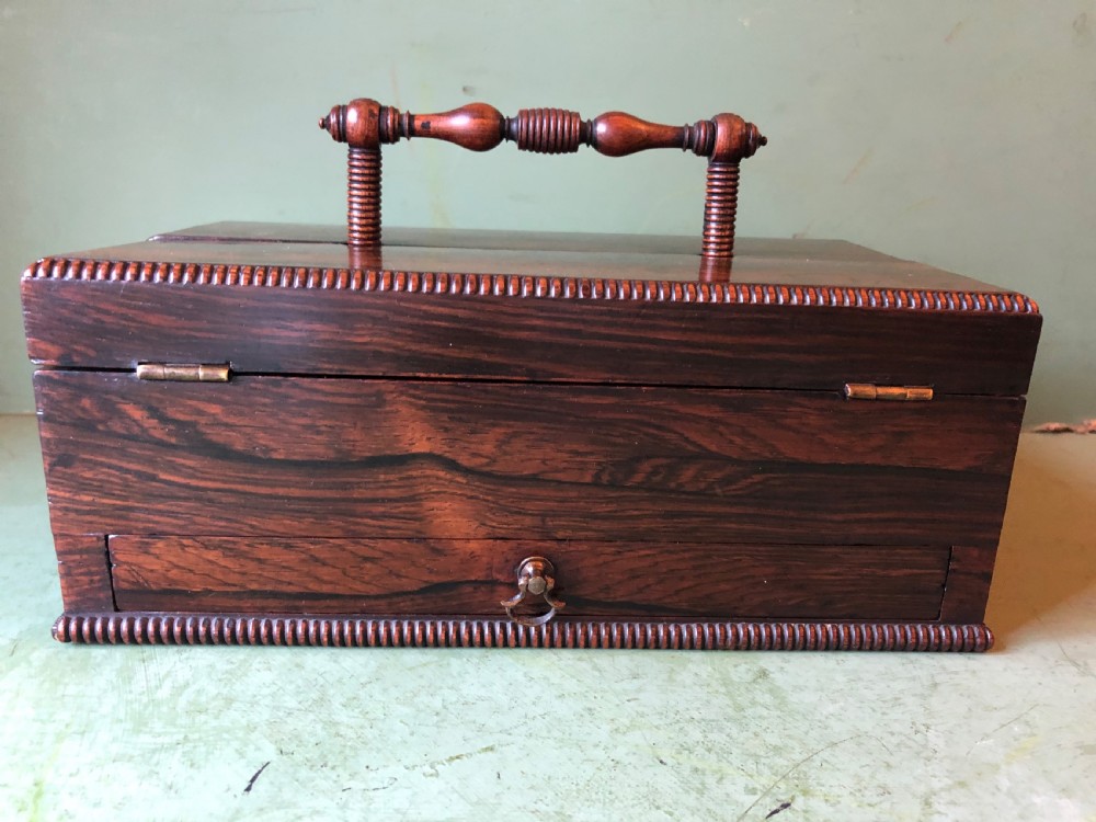 A dark rosewood rectangular desk tidy featuring a central turned wood and brass handle, hinged lids, and a moulded base. View XV
