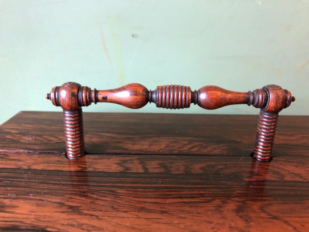 A dark rosewood rectangular desk tidy featuring a central turned wood and brass handle, hinged lids, and a moulded base. View XVI