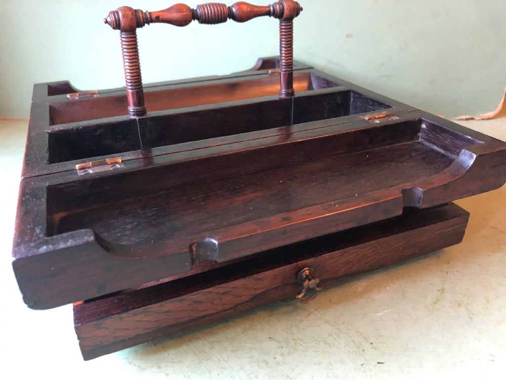 A dark rosewood rectangular desk tidy featuring a central turned wood and brass handle, hinged lids, and a moulded base. View XVII
