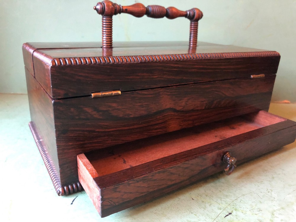 A dark rosewood rectangular desk tidy featuring a central turned wood and brass handle, hinged lids, and a moulded base. View XIX
