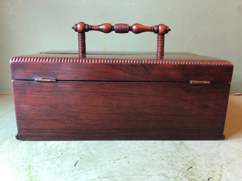 A dark rosewood rectangular desk tidy featuring a central turned wood and brass handle, hinged lids, and a moulded base. View XXI