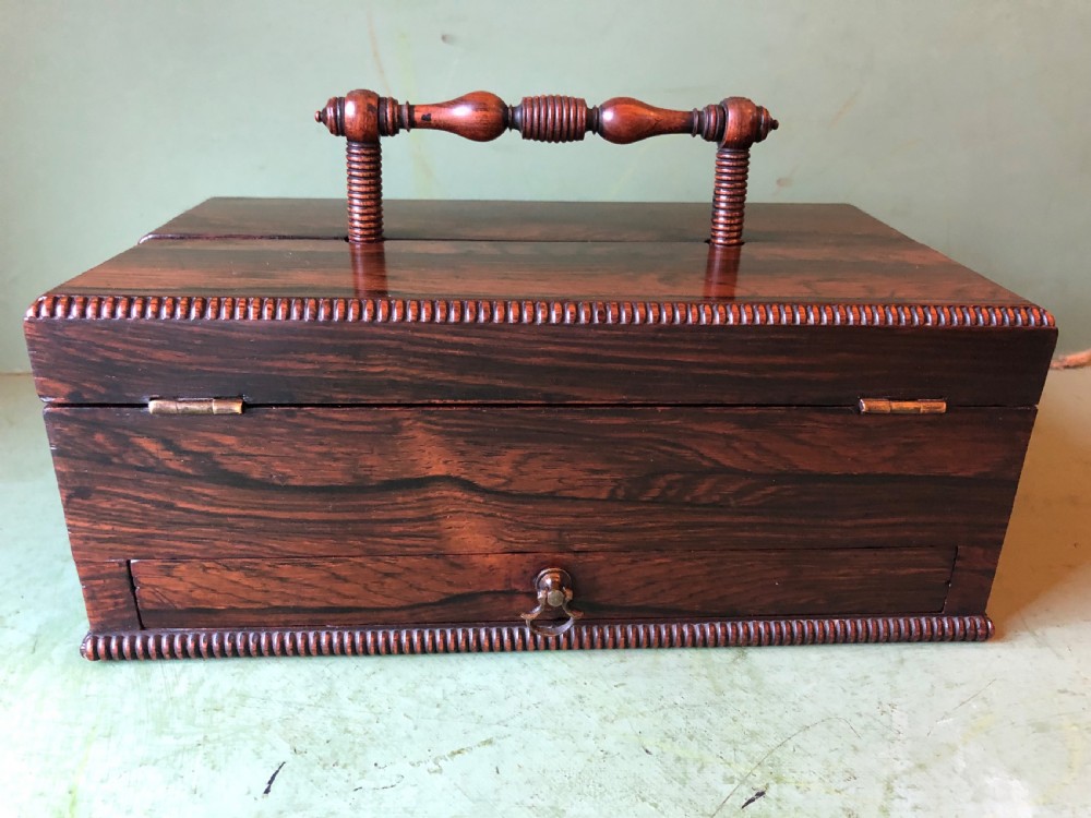 A dark rosewood rectangular desk tidy featuring a central turned wood and brass handle, hinged lids, and a moulded base. View XXIII