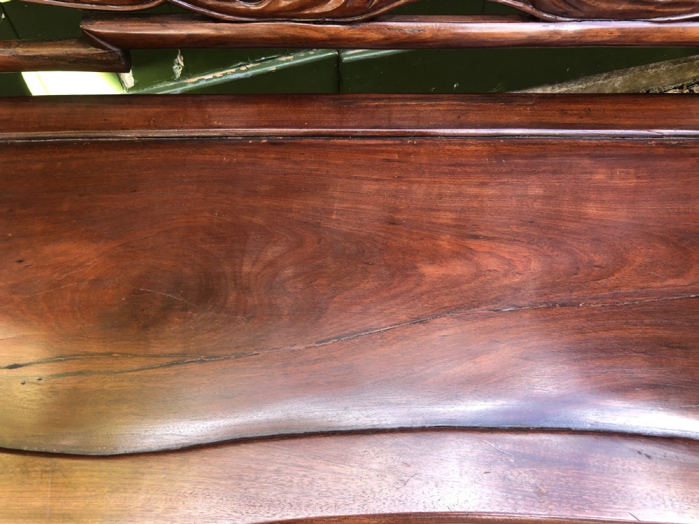 An antique Chinese dark hardwood hall bench featuring detailed relief carvings of bats, landscapes, and traditional character motifs on the backrest. View XIV