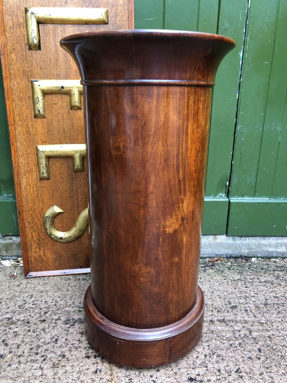 An early nineteenth-century French Empire mahogany cylindrical cupboard featuring an inset marble top, a single curved door with a small brass knob, and a plinth base. View X