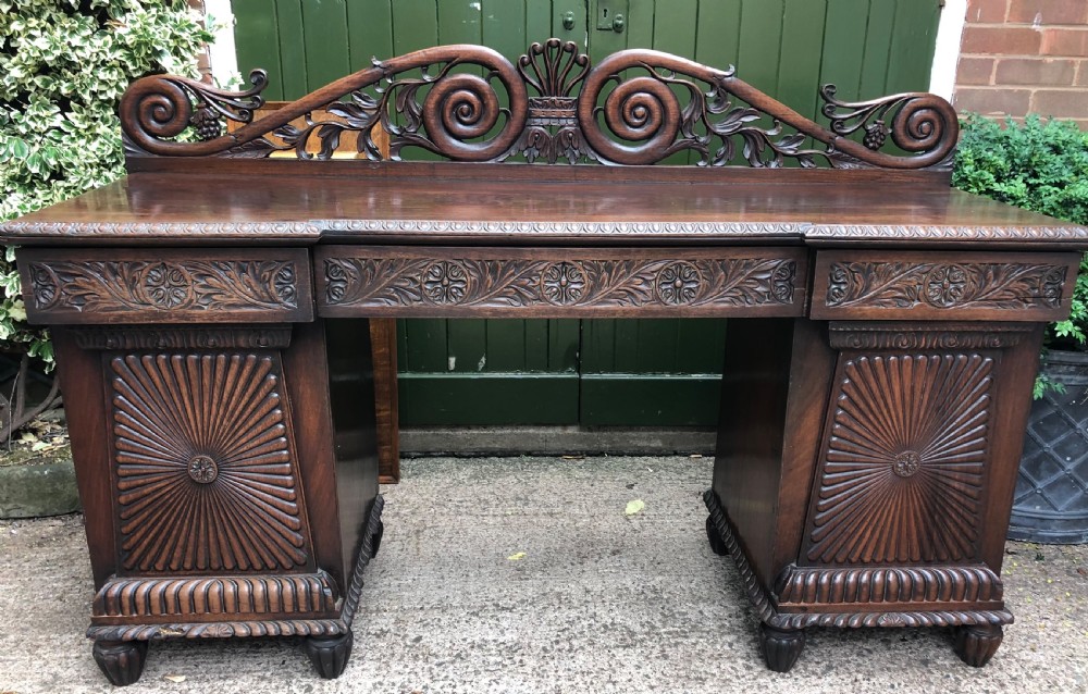 C19th Anglo-Indian carved padauk pedestal sideboard.