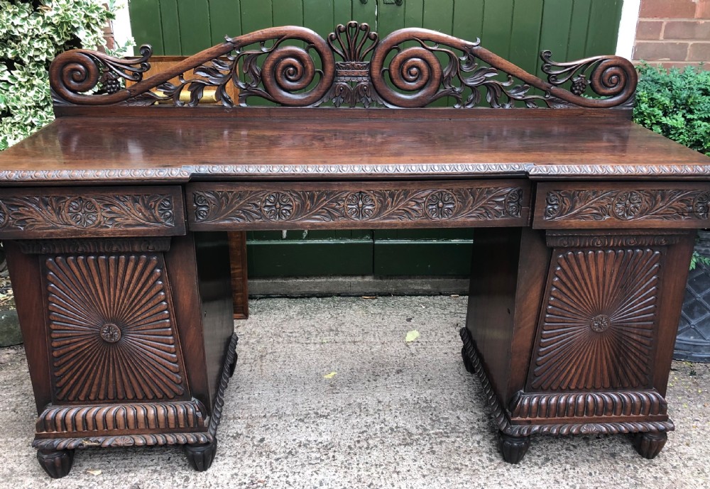 C19th Anglo-Indian carved padauk pedestal sideboard. View II