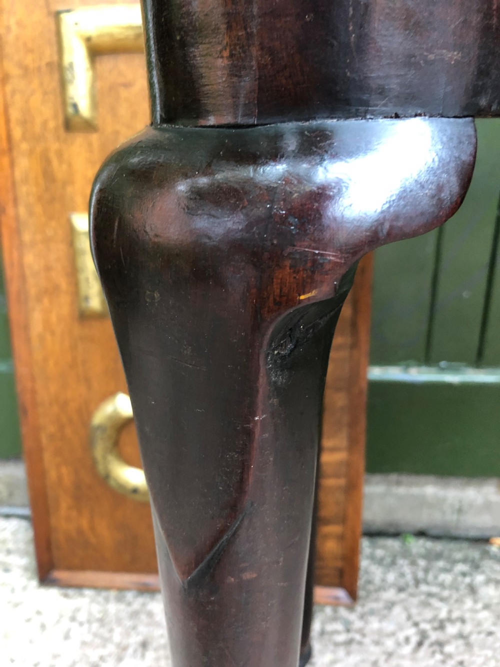 A mid-18th-century George II mahogany fold-over card table featuring slender cabriole legs terminating in pad feet and a shaped top. View II