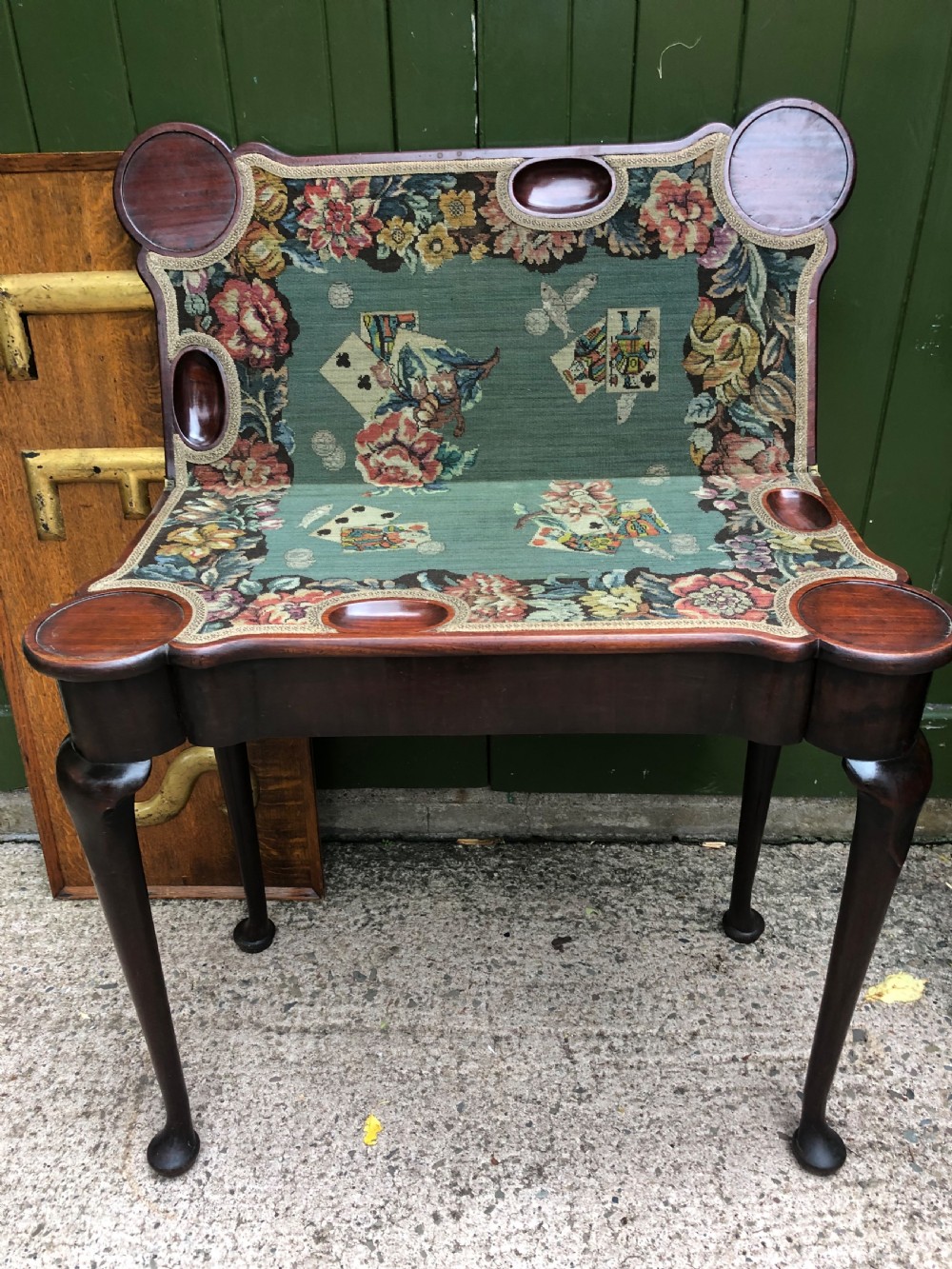 A mid-18th-century George II mahogany fold-over card table featuring slender cabriole legs terminating in pad feet and a shaped top. View III