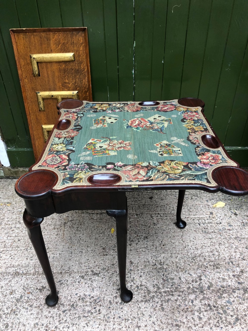 A mid-18th-century George II mahogany fold-over card table featuring slender cabriole legs terminating in pad feet and a shaped top. View V