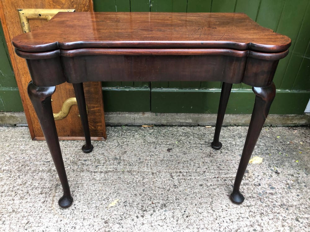 A mid-18th-century George II mahogany fold-over card table featuring slender cabriole legs terminating in pad feet and a shaped top. View VII