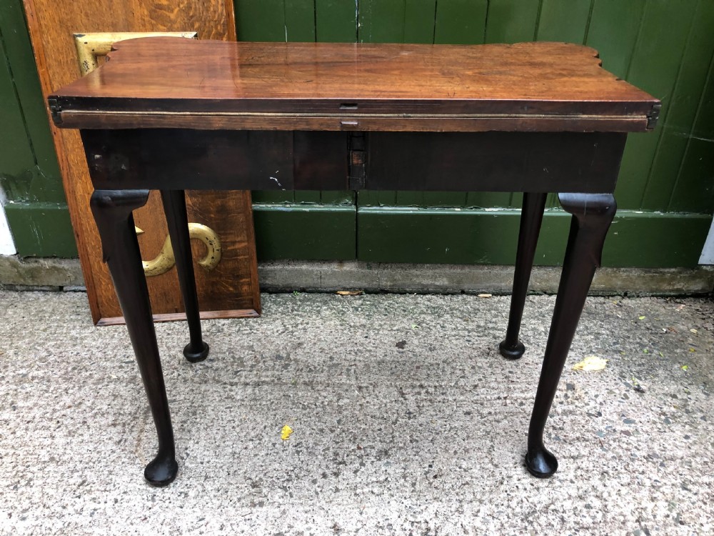 A mid-18th-century George II mahogany fold-over card table featuring slender cabriole legs terminating in pad feet and a shaped top. View IX