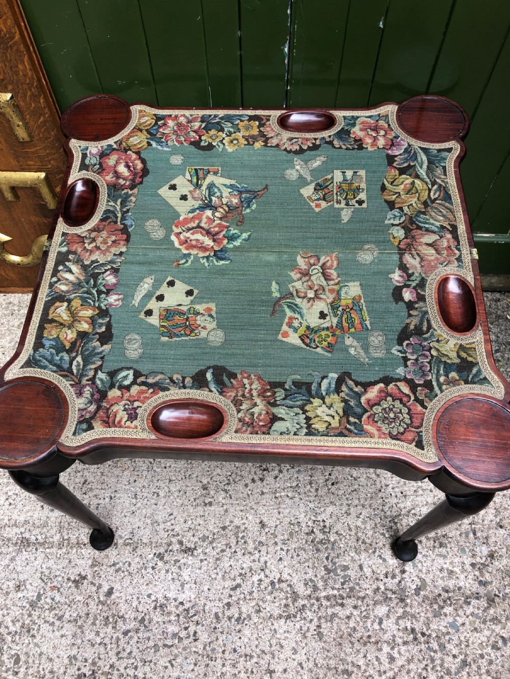 A mid-18th-century George II mahogany fold-over card table featuring slender cabriole legs terminating in pad feet and a shaped top. View XX