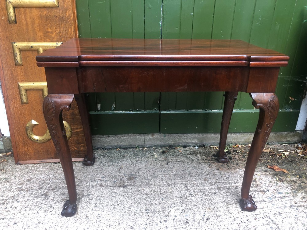A mid-18th-century George II mahogany fold-over card table featuring carved cabriole legs and claw and ball feet. View II