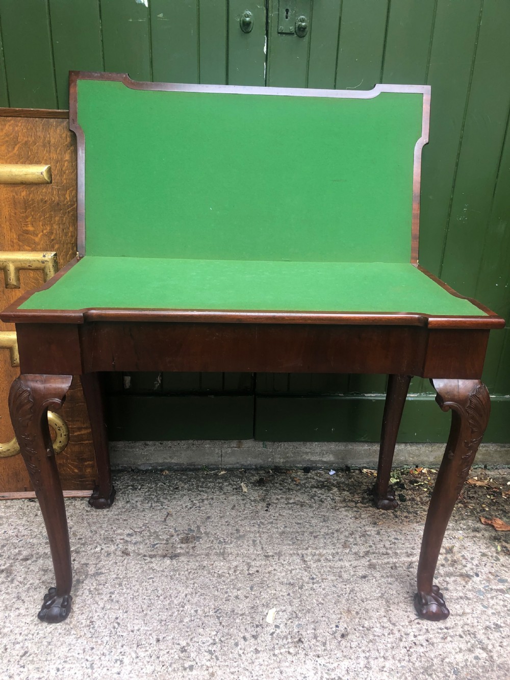 A mid-18th-century George II mahogany fold-over card table featuring carved cabriole legs and claw and ball feet. View VII