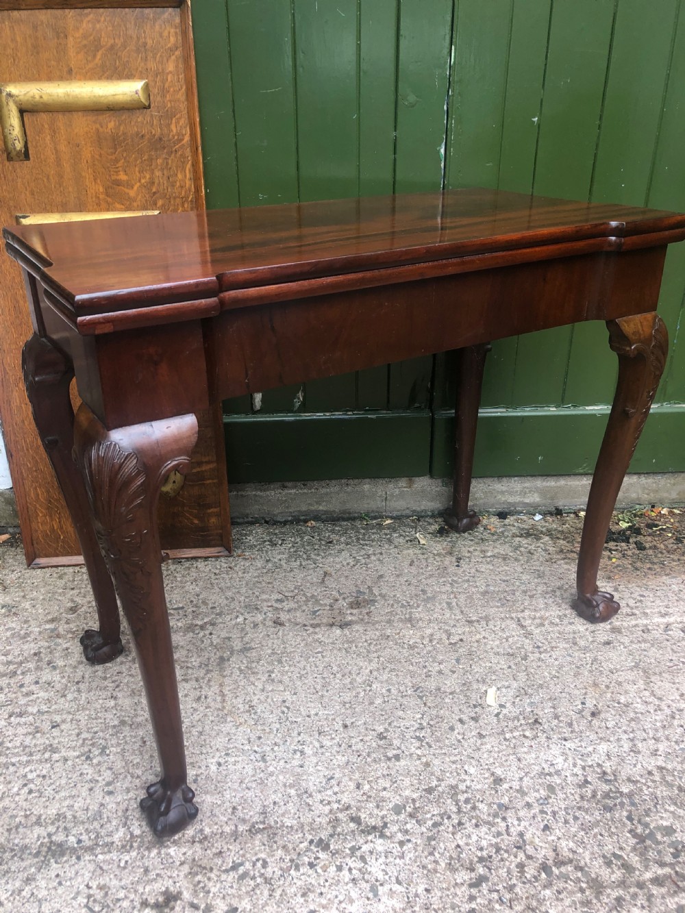 A mid-18th-century George II mahogany fold-over card table featuring carved cabriole legs and claw and ball feet. View IX