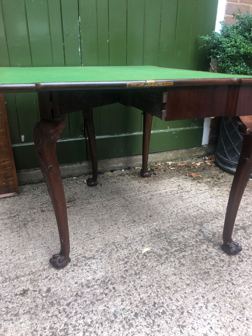A mid-18th-century George II mahogany fold-over card table featuring carved cabriole legs and claw and ball feet. View XI