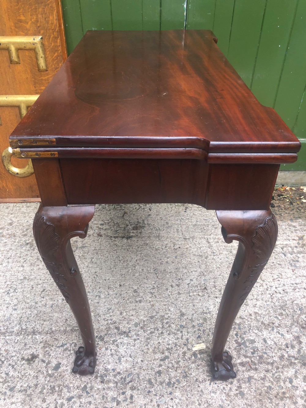 A mid-18th-century George II mahogany fold-over card table featuring carved cabriole legs and claw and ball feet. View XII