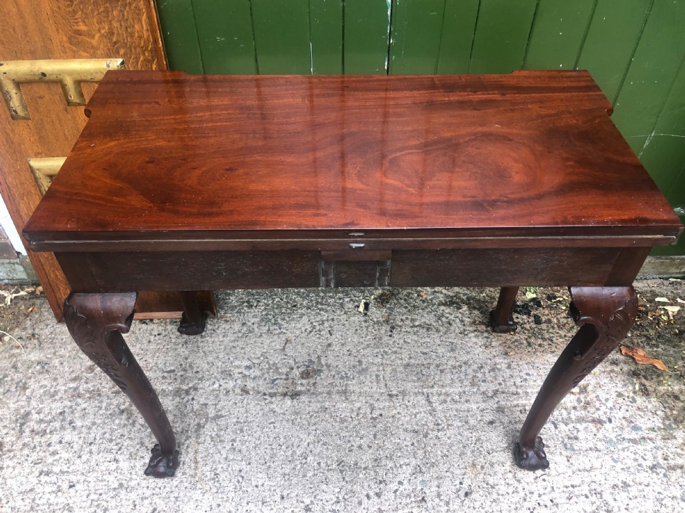 A mid-18th-century George II mahogany fold-over card table featuring carved cabriole legs and claw and ball feet. View XIV