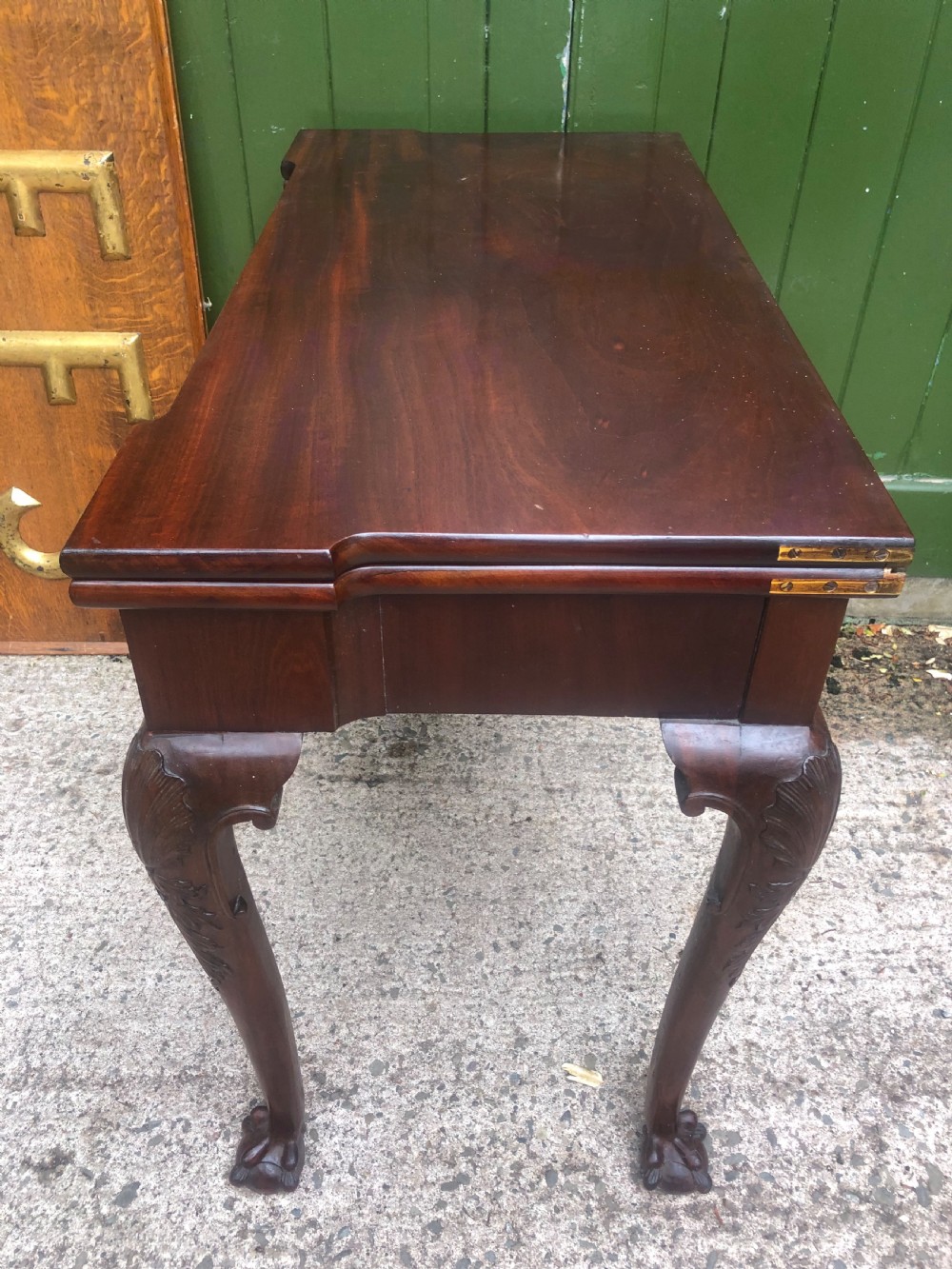 A mid-18th-century George II mahogany fold-over card table featuring carved cabriole legs and claw and ball feet. View XV