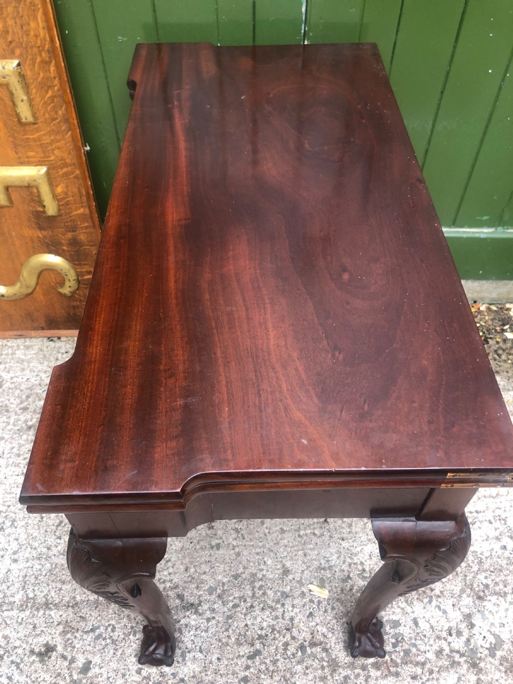 A mid-18th-century George II mahogany fold-over card table featuring carved cabriole legs and claw and ball feet. View XVI