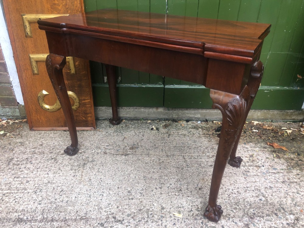 A mid-18th-century George II mahogany fold-over card table featuring carved cabriole legs and claw and ball feet. View XVII