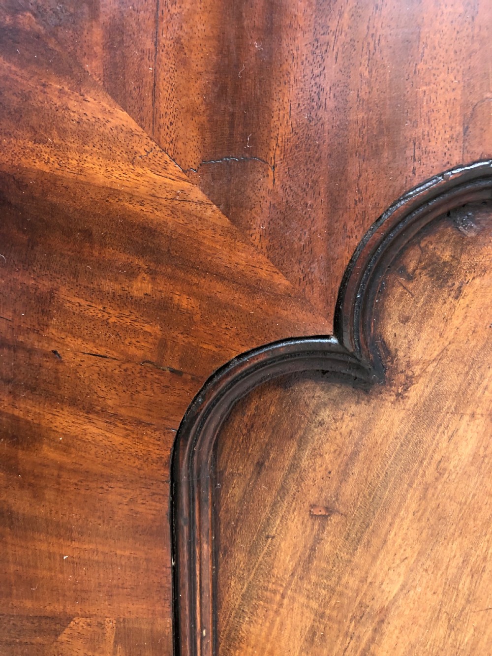 An early 19th-century George IV flame mahogany breakfront library bookcase featuring four upper glazed doors with astragal glazing bars above four fielded panel lower cupboards. View XI