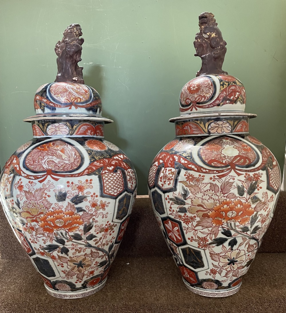 Pair of large late C17th / early C18th Japanese Genroku period porcelain vases and covers decorated in the Imari palette.