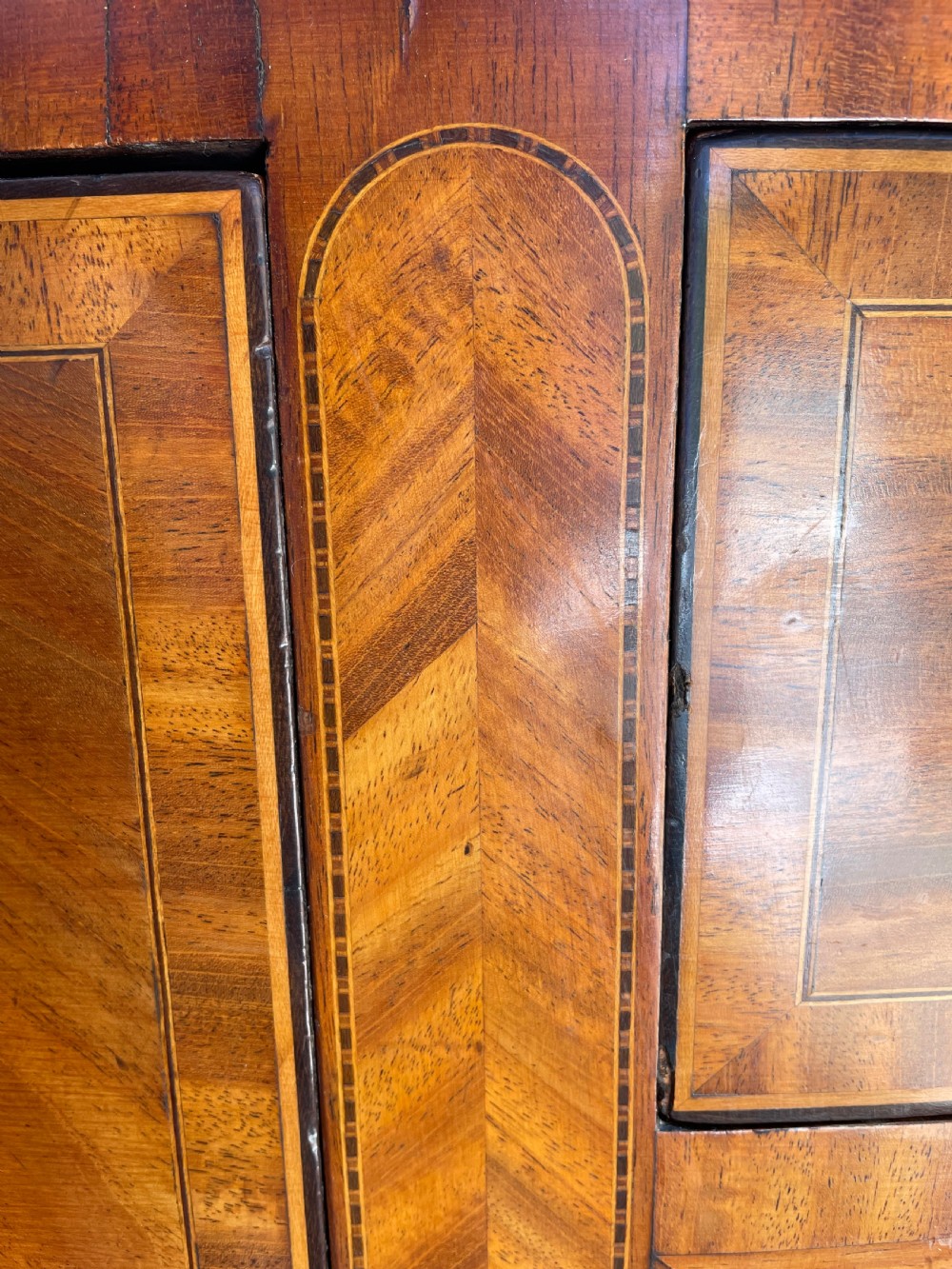 A late 18th-century George III mahogany demi-lune sideboard featuring inlaid stringing, a central drawer, curved side doors, and tapered square legs. View XV