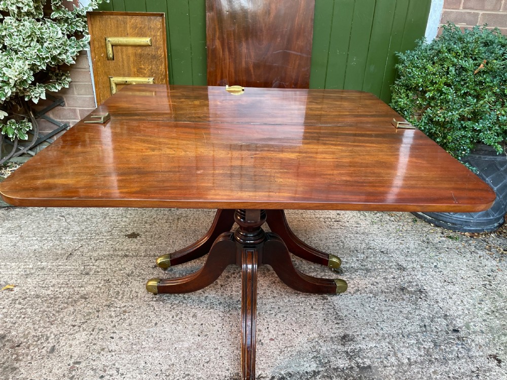 Early C19th Regency period mahogany twin-pillar dining table . View III
