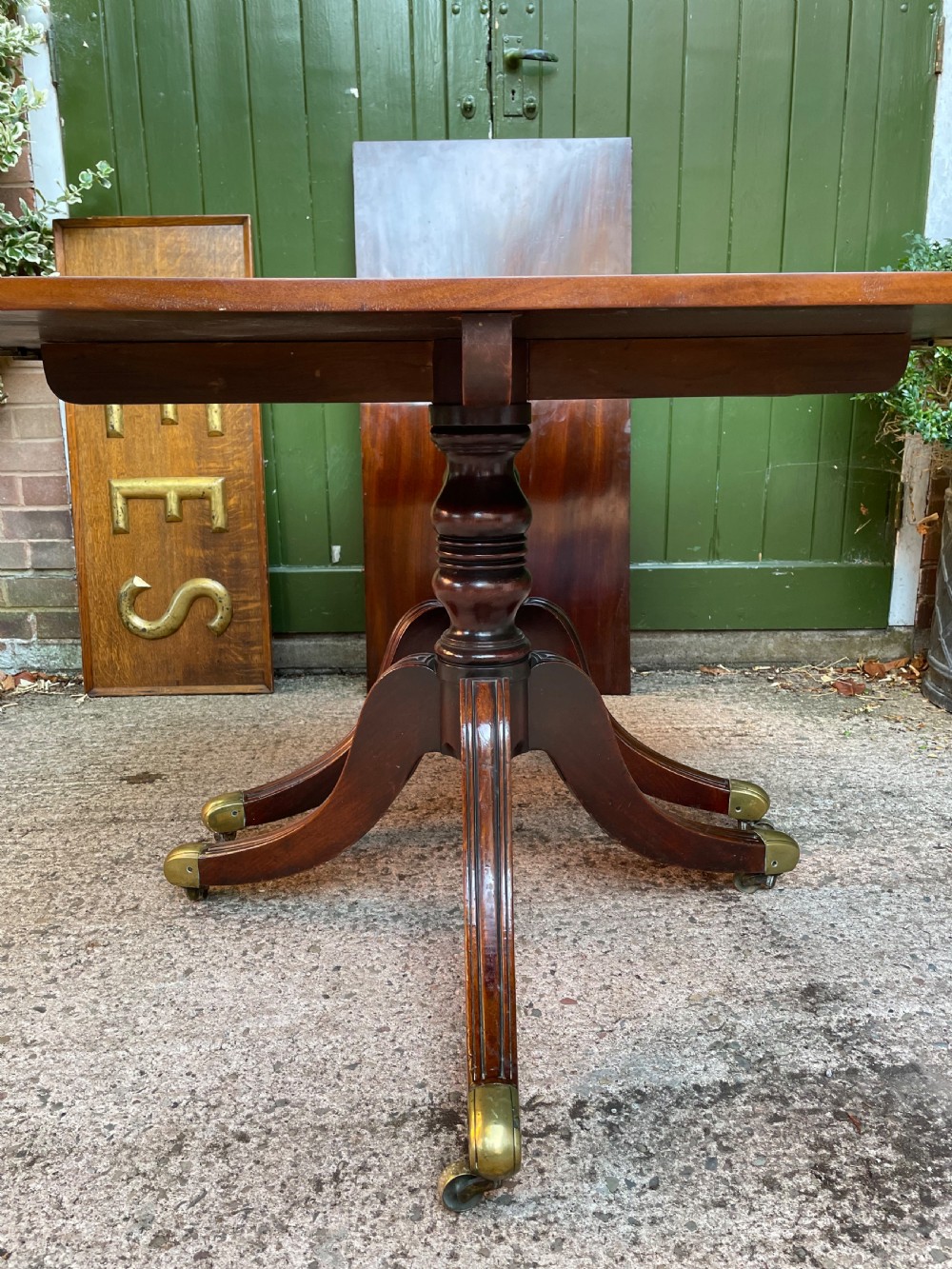 Early C19th Regency period mahogany twin-pillar dining table . View VI