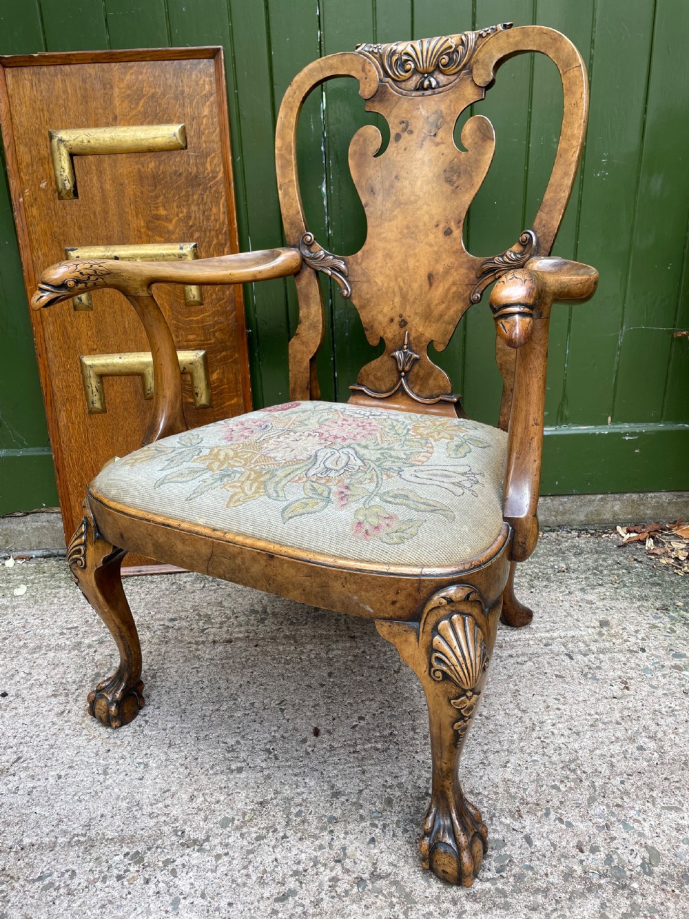 A carved walnut open armchair featuring carved eagle head arm terminals, a vasiform splat back, and floral tapestry upholstery. View II