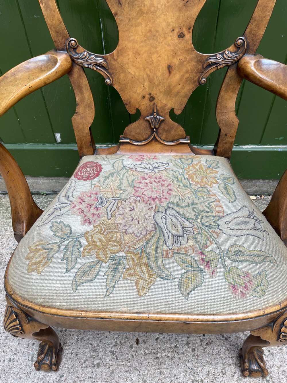 A carved walnut open armchair featuring carved eagle head arm terminals, a vasiform splat back, and floral tapestry upholstery. View VIII