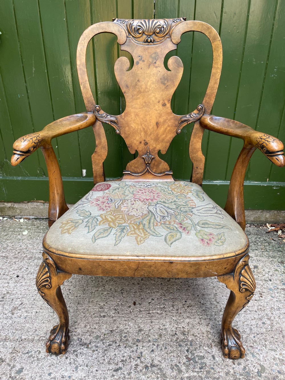 A carved walnut open armchair featuring carved eagle head arm terminals, a vasiform splat back, and floral tapestry upholstery. View XI