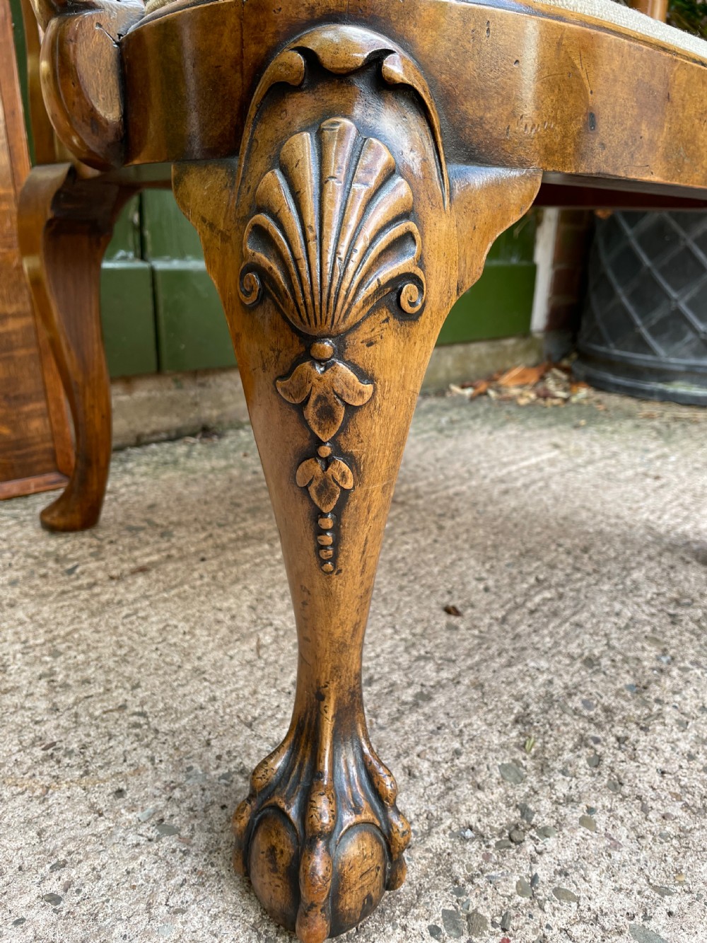 A carved walnut open armchair featuring carved eagle head arm terminals, a vasiform splat back, and floral tapestry upholstery. View XII