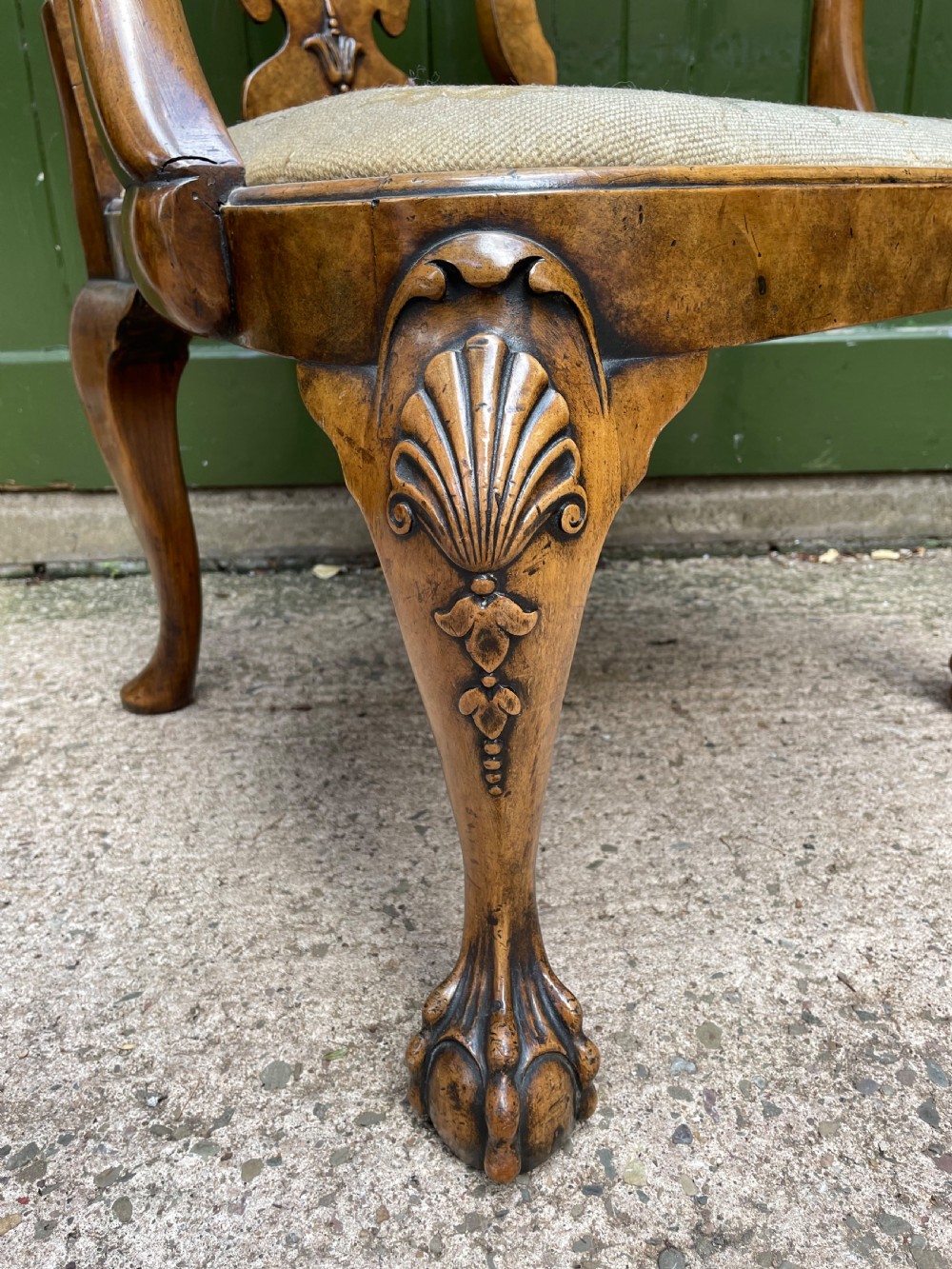 A carved walnut open armchair featuring carved eagle head arm terminals, a vasiform splat back, and floral tapestry upholstery. View XIII