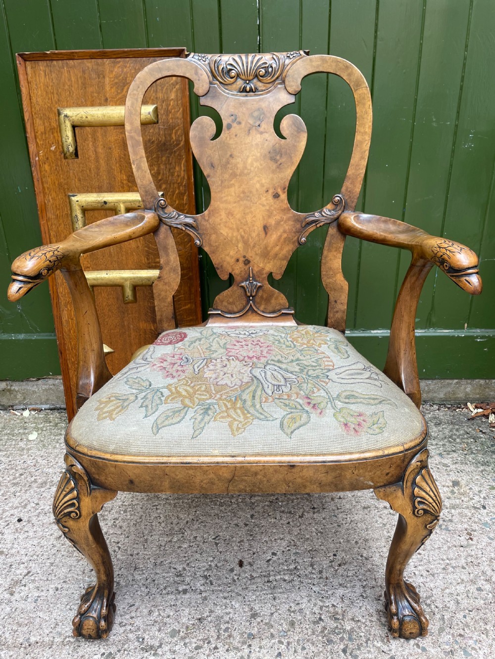 A carved walnut open armchair featuring carved eagle head arm terminals, a vasiform splat back, and floral tapestry upholstery. View XV