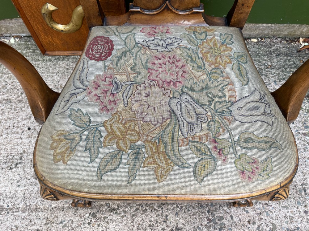 A carved walnut open armchair featuring carved eagle head arm terminals, a vasiform splat back, and floral tapestry upholstery. View III