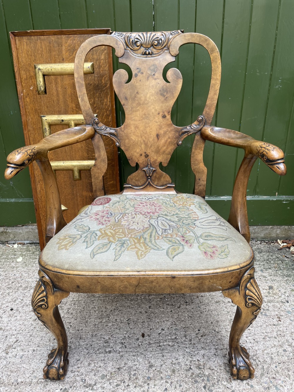 A carved walnut open armchair featuring carved eagle head arm terminals, a vasiform splat back, and floral tapestry upholstery. View XXVII