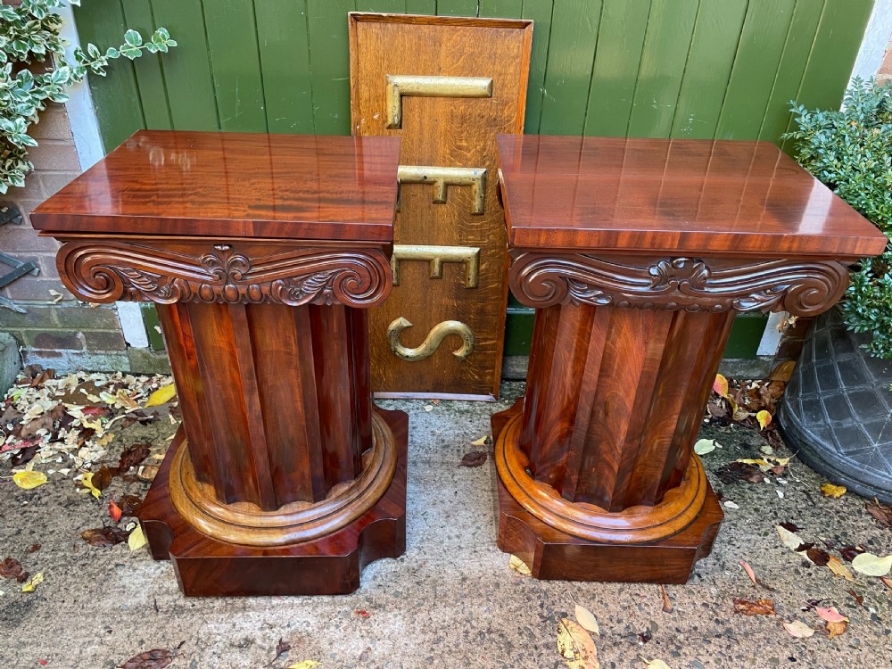 A matched pair of William IV mahogany pedestals designed in classical ionic column form with fluted shafts and stepped bases. View II