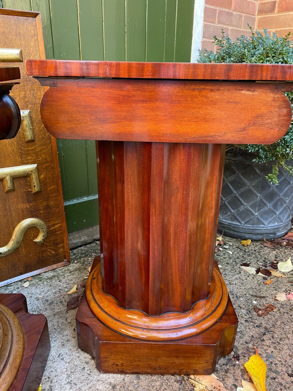 A matched pair of William IV mahogany pedestals designed in classical ionic column form with fluted shafts and stepped bases. View XI