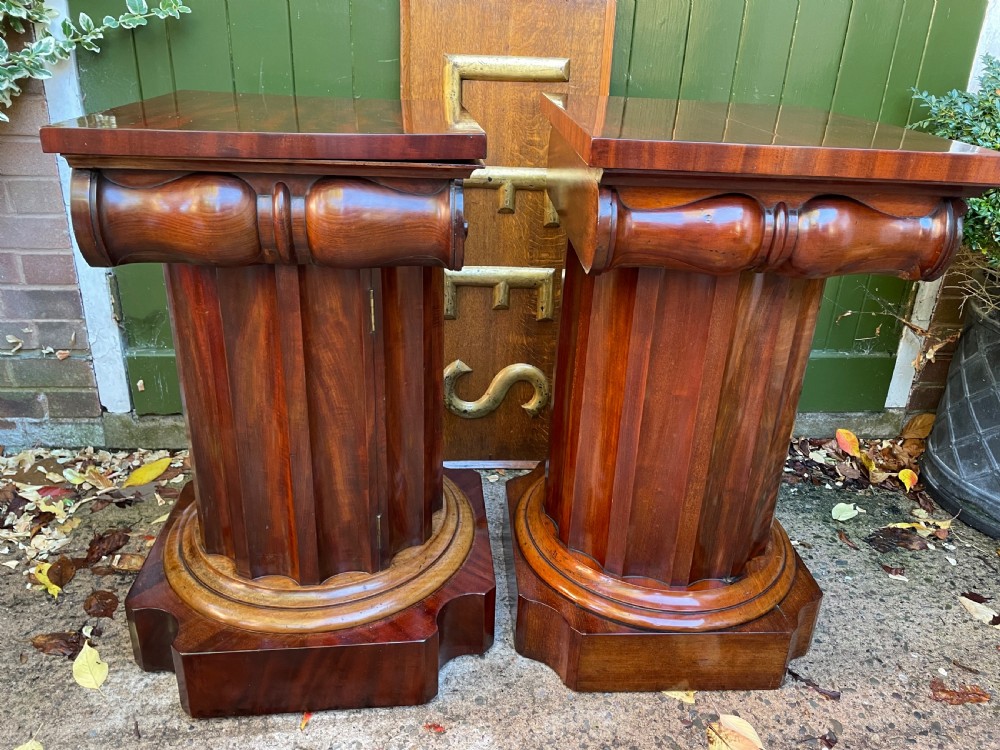 A matched pair of William IV mahogany pedestals designed in classical ionic column form with fluted shafts and stepped bases. View XIII