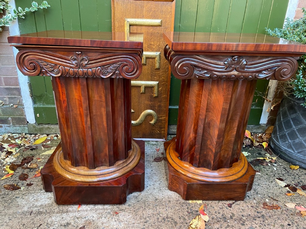 A matched pair of William IV mahogany pedestals designed in classical ionic column form with fluted shafts and stepped bases. View XVII