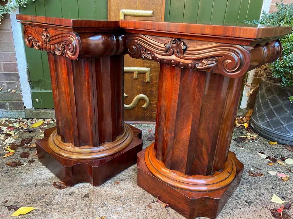 A matched pair of William IV mahogany pedestals designed in classical ionic column form with fluted shafts and stepped bases. View XXIV
