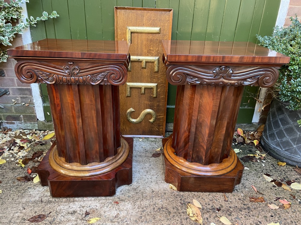 A matched pair of William IV mahogany pedestals designed in classical ionic column form with fluted shafts and stepped bases. View XXVI