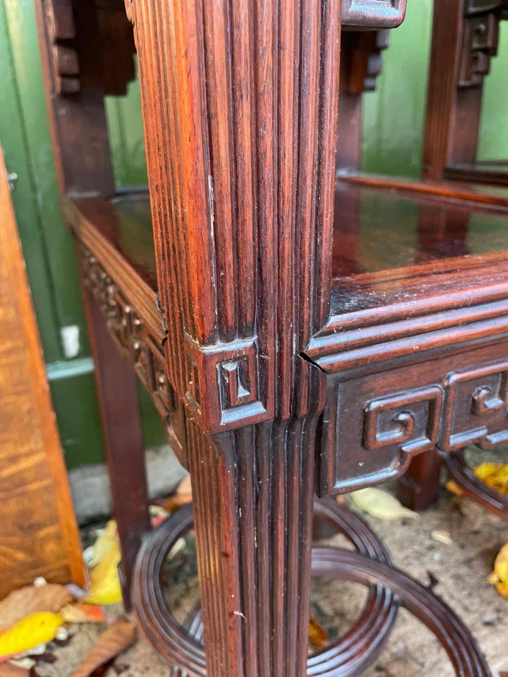 A pair of late nineteenth-century Chinese carved dark hardwood two-tier stands featuring inset marble tops, carved openwork aprons, and interlocking ring stretchers. View VII