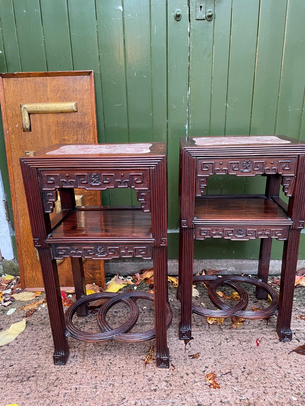 A pair of late nineteenth-century Chinese carved dark hardwood two-tier stands featuring inset marble tops, carved openwork aprons, and interlocking ring stretchers. View XI