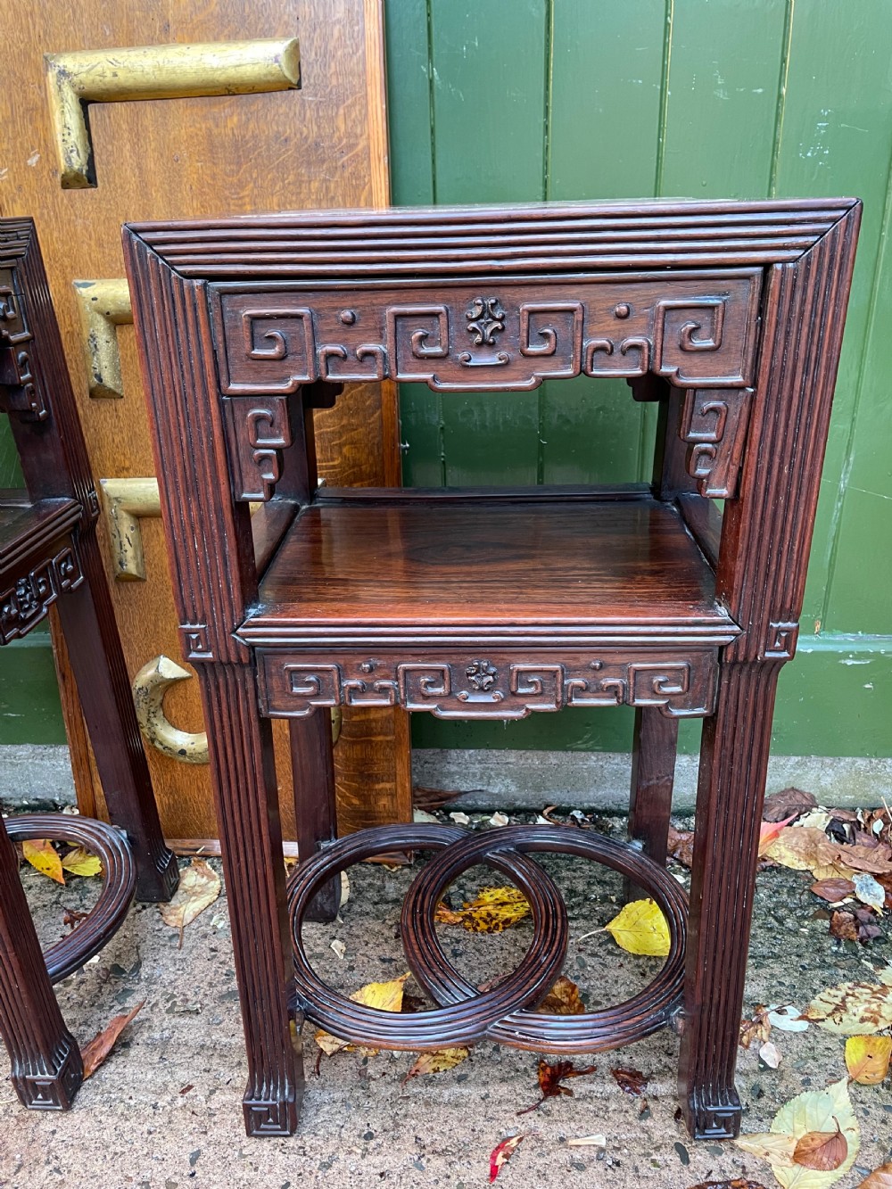 A pair of late nineteenth-century Chinese carved dark hardwood two-tier stands featuring inset marble tops, carved openwork aprons, and interlocking ring stretchers. View XVIII